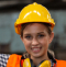 A young girl wearing a hard hat